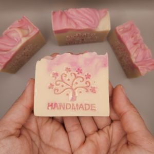 Hands holding a bar of handmade soap